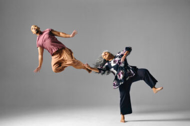 Alumnus Jason Galeos and faculty member Michèle Moss leap with characteristic joy.