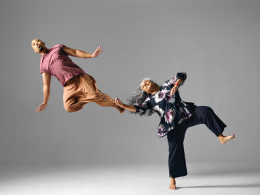 Alumnus Jason Galeos and faculty member Michèle Moss leap with characteristic joy.